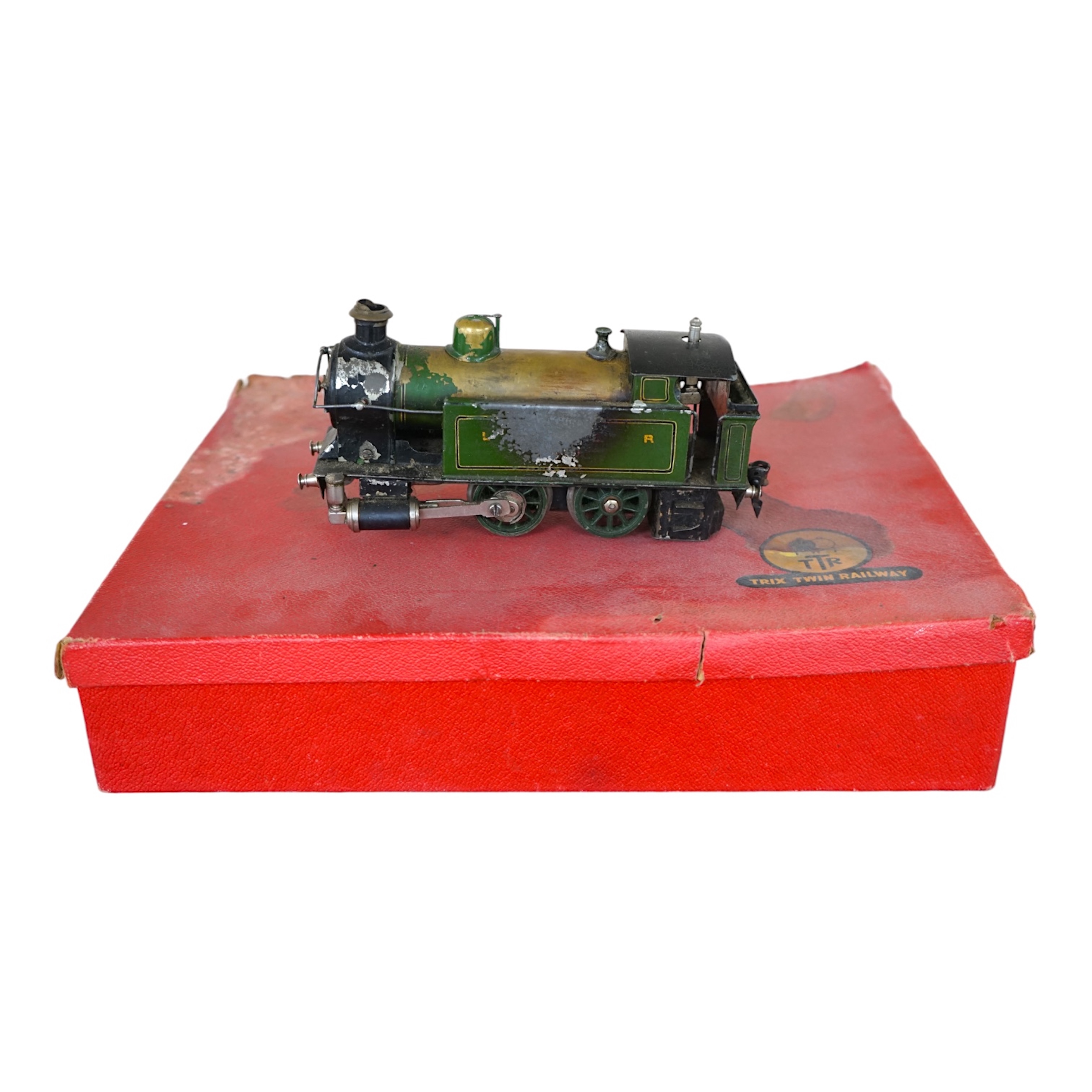 A Trix Twin Railway 00 gauge train set box containing; four locomotives, eight bogie coaches, two railcars, and six freight wagons, together with a live steam Marklin 0-4-0T LNER locomotive. Condition - poor to fair.